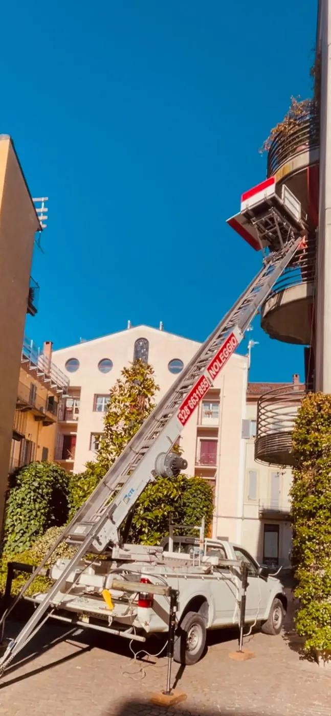 Autoscala a noleggio Dergesat al lavoro in un cortile